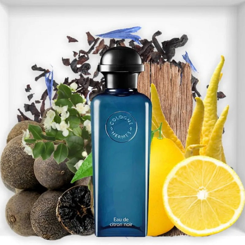 Blue cologne bottle with natural elements like lemon, vanilla, and wood on a white background