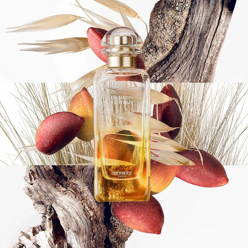 Hermes perfume bottle with fruits and natural elements on a white background