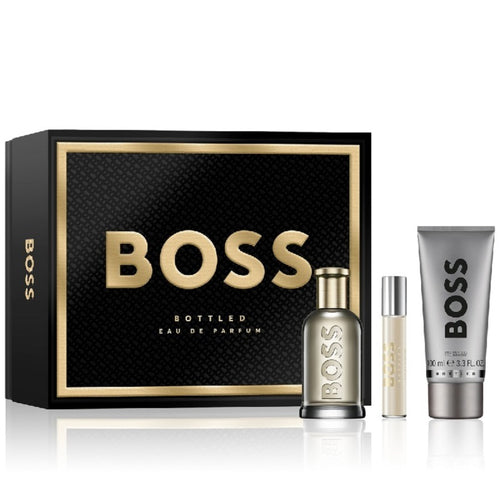 Boss Bottled Gift Set by Hugo Boss, containing a 100ml Eau De Parfum Spray bottle, a travel spray, and a 100ml Shower Gel tube, all presented in a black box with gold accents.