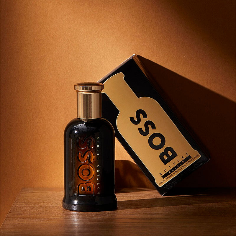 BOSS bottle and packaging on a wooden surface with a brown background