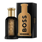 Hugo Boss Boss Bottled Elixer Eau de Parfum bottle and packaging, featuring a black bottle with gold details and a box with product information.