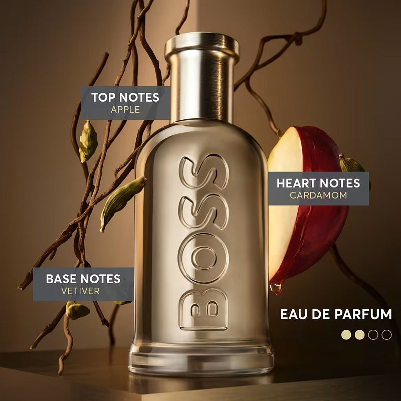 BOSS eau de parfum bottle with apple and cardamom elements on a brown background
