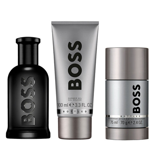 BOSS men's grooming products including a bottle, shower gel, and deodorant stick on a white background.