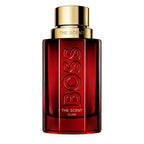 Hugo Boss The Scent Elixir for Him 100ml Parfum Intense deep-red lacquered glass bottle with faceted contours, bold BOSS lettering and satin warm-gold cap on a clean white background.