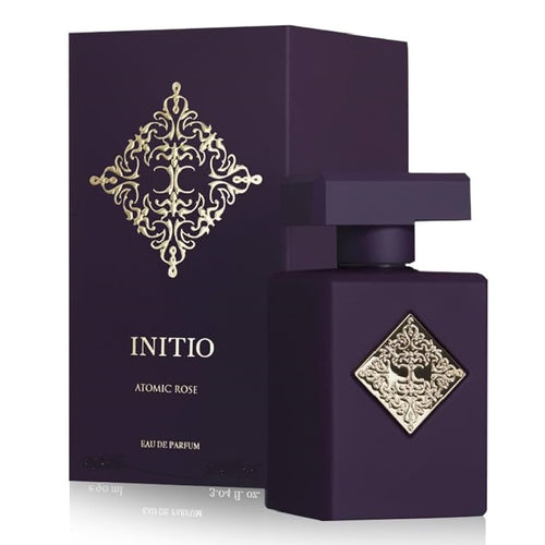 Purple perfume bottle and packaging with gold decorative elements on a white background