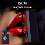 Initio parfum bottle and packaging with red lips in the background