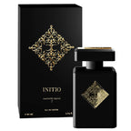 Black eau de parfum bottle with gold decorative elements, labeled 'INITIO Magnetic Blend', alongside its black box packaging with similar design.