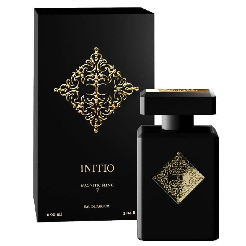 Black eau de parfum bottle with gold decorative elements, labeled 'INITIO Magnetic Blend', alongside its black box packaging with similar design.