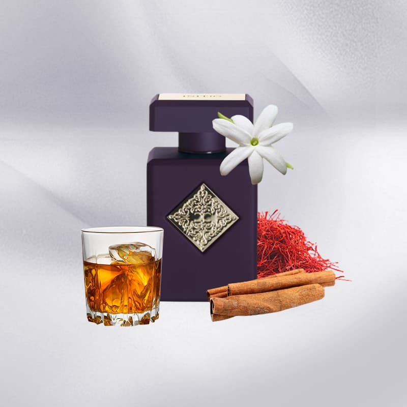 Purple perfume bottle with a glass of amber liquid, cinnamon sticks, and a white flower on a light gray background.