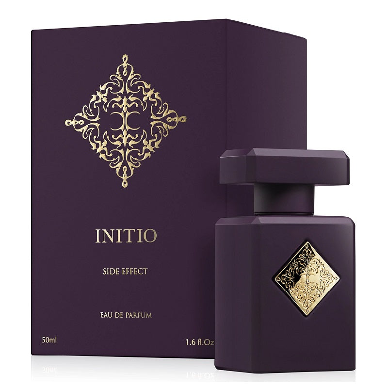 Purple perfume bottle with gold detailing and matching box on a white background