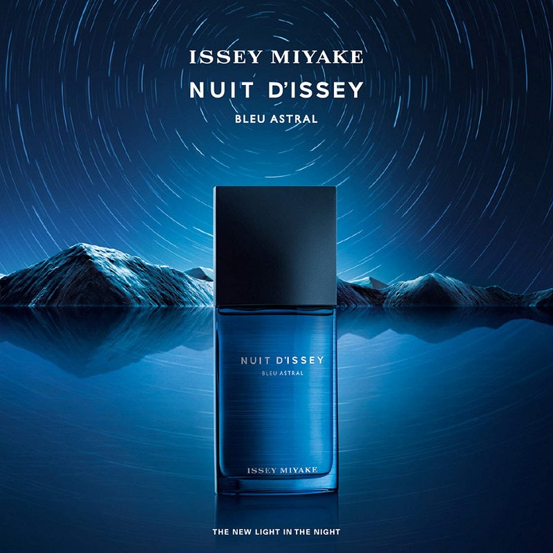 Blue perfume bottle with starry night sky and mountain background