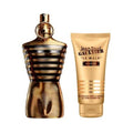 Jean Paul Gaultier Le Male Elixir shower gel set, featuring a metallic gold and black striped perfume bottle next to a matching gold shower gel tube on a white background.