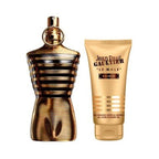 Jean Paul Gaultier Le Male Elixir shower gel set, featuring a metallic gold and black striped perfume bottle next to a matching gold shower gel tube on a white background.