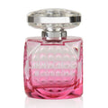 A pink glass bottle of Jimmy Choo Blossom Eau de Parfum with a silver cap.