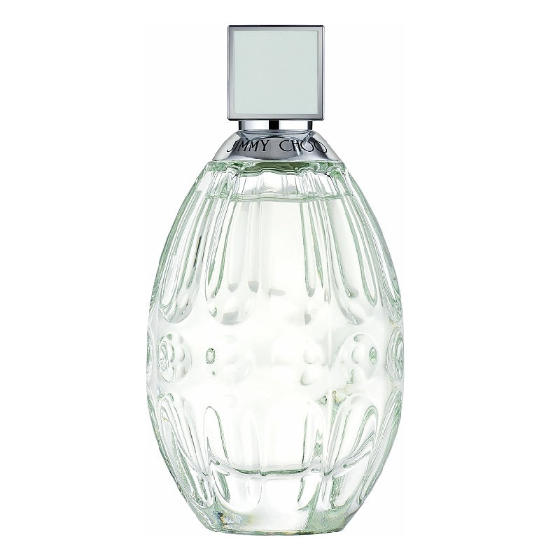 Clear glass perfume bottle with silver cap on a white background