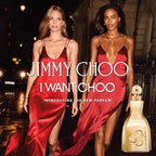 Two women in red dresses standing next to a gold perfume bottle with 'Jimmy Choo' branding.