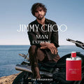 Man sitting on a motorcycle with Jimmy Choo Man Extreme fragrance bottle by the ocean.