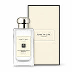Jo Malone London Nectarine Blossom & Honey Cologne bottle in a clear glass rectangular bottle with a silver cap, shown next to its cream-colored textured packaging box on a white background.