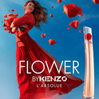 Advertisement for 'Flower by Kenzo L'Absolue' with a woman in a red dress and flying red flowers against a blue sky.