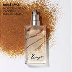 Kenzo perfume bottle with spice dust on a white background