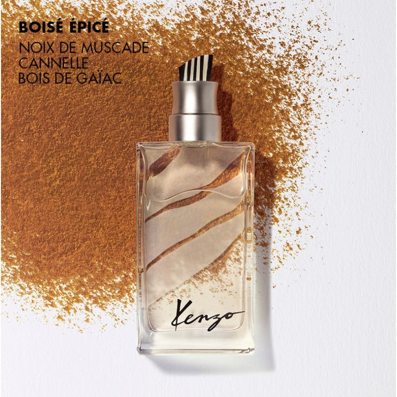 Kenzo perfume bottle with spice dust on a white background