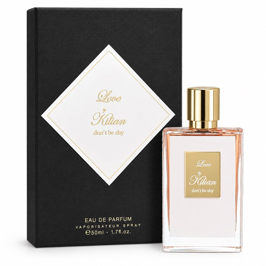 A bottle of Love by Kilian Eau de Parfum with a gold cap and a clear glass body showing a pale pink liquid, standing next to its black textured packaging box with a white diamond label.
