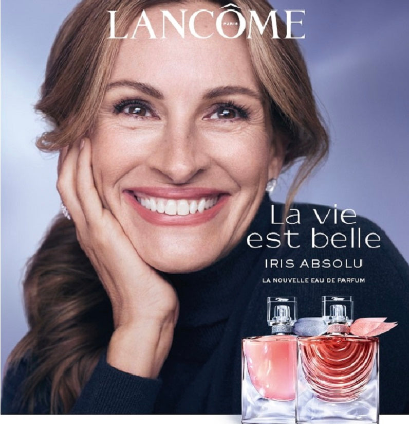 Lancome advertisement with a woman smiling and two perfume bottles on a gradient background