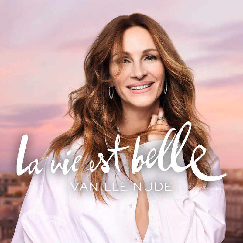 Woman with long brown hair wearing a white shirt against a pink sky with 'La vie est belle' text.
