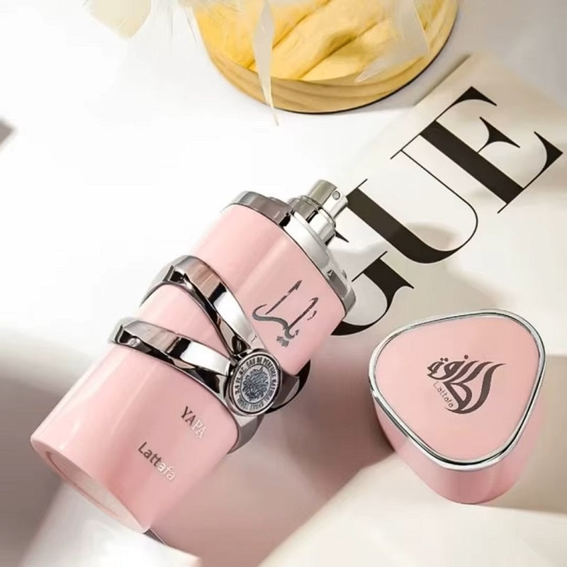 Pink perfume bottles with silver accents on a Vogue magazine