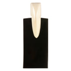 Black wall sconce with a white cylindrical light fixture on a white background