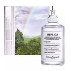 Maison Margiela replica perfume bottle with a scenic background of trees and a rainbow.