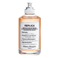 A bottle of Maison Margiela Autumn Vibes Eau de Toilette with a spray nozzle, labeled with the product information.