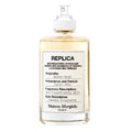 A bottle of Maison Margiela Beach Walk Eau de Toilette with the label detailing the fragrance description and notes.