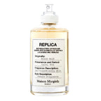 A bottle of Maison Margiela Beach Walk Eau de Toilette with the label detailing the fragrance description and notes.