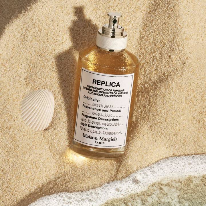Replica perfume bottle on sand with shell