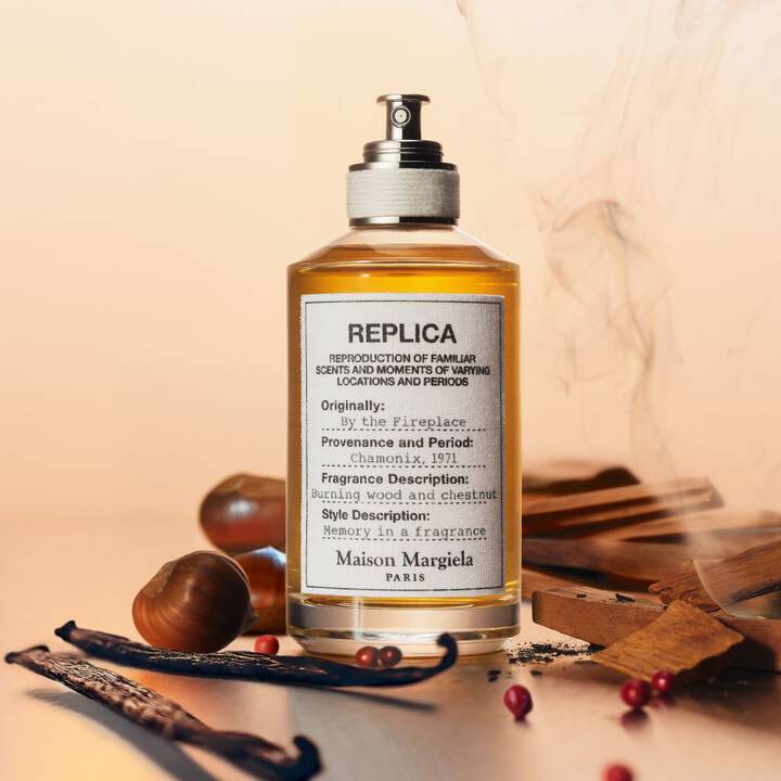 Maison Margiela replica fragrance bottle with vanilla beans and cinnamon sticks on a beige background