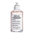 Perfume bottle with white cap and clear body on a white background