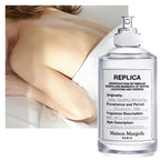Maison Margiela Lazy Sunday Morning 100ml Eau de Toilette lifestyle image inspired by crisp white linen, soft morning sunlight, fresh flowers and a peaceful bedroom retreat.