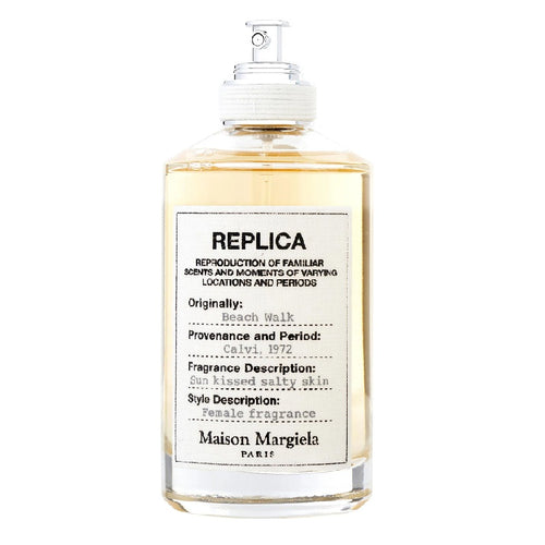A bottle of Maison Margiela Replica Beach Walk Eau de Toilette with the label detailing the fragrance description and notes.