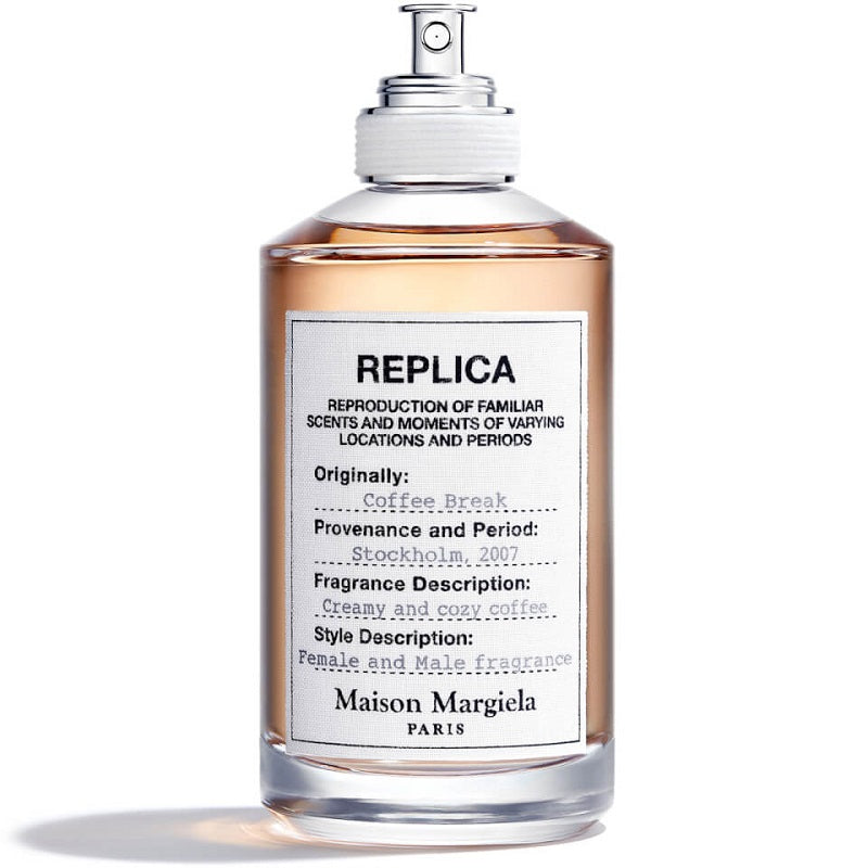 A bottle of Maison Margiela Coffee Break Eau de Toilette with a white label, transparent bottle, and a brown liquid inside.