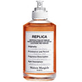 A bottle of Maison Margiela fragrance, specifically the 'Under the Stars' variant, with a spray nozzle, labeled with the product name and brand.