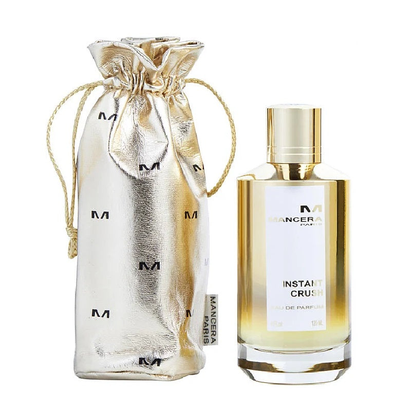 Perfume bottle labeled 'Instant Crush' with a matching silver drawstring bag on a white background