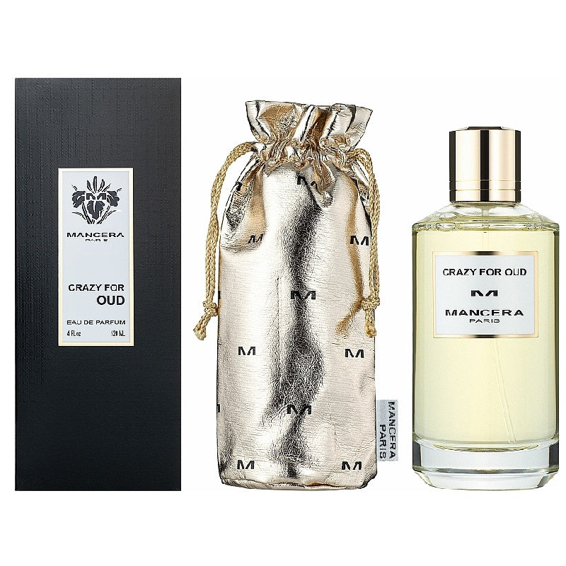 120ml bottle of 'Crazy for Oud' Eau De Parfum by Mancera, alongside its packaging and a metallic drawstring pouch. The perfume bottle is clear with a gold cap, and the packaging is primarily black with white text.