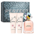 Marc Jacobs Perfect perfume set with bottle and two body lotions in front of a sequin background.