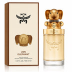 MCM Zen Elephant Eau de Parfum bottle and its retail box, featuring a gold elephant-shaped cap and a beige box with brown borders.
