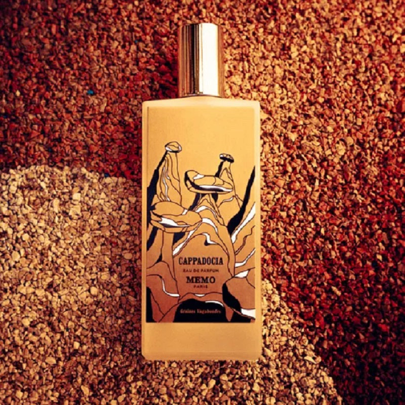 Perfume bottle with artistic design on a textured brown background