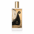A rectangular white perfume bottle with a gold cap, featuring a graphic label of a Viking longship on a gold background. The text on the label reads 'FLÂM EAU DE PARFUM MEMO PARIS' and 'Grain de Terre'.