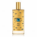 Memo Paris Marfa Eau de Parfum bottle with a gold cap and a gold body decorated with illustrated eyes, including a prominent blue and black eye in the center, on a white background.