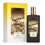 Memo Paris Odeon Eau de Parfum bottle next to its packaging box. The bottle is black with a metallic rose gold cap, and the box features a yellow-to-white gradient with a sepia-toned illustration of Parisian rooftops.