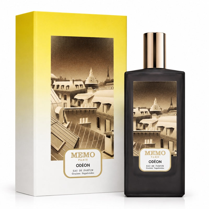 Memo Paris Odeon Eau de Parfum bottle next to its packaging box. The bottle is black with a metallic rose gold cap, and the box features a yellow-to-white gradient with a sepia-toned illustration of Parisian rooftops.